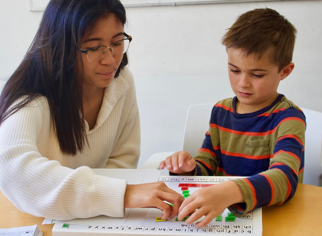 Student and tutor using interactive phonics board.